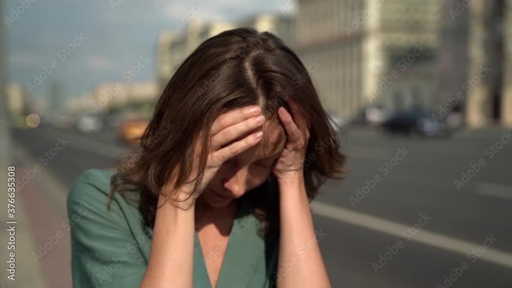 depressed disoriented woman is walking along road in big city, medium portrait depressed disoriented woman is walking along road in big city, medium portrait