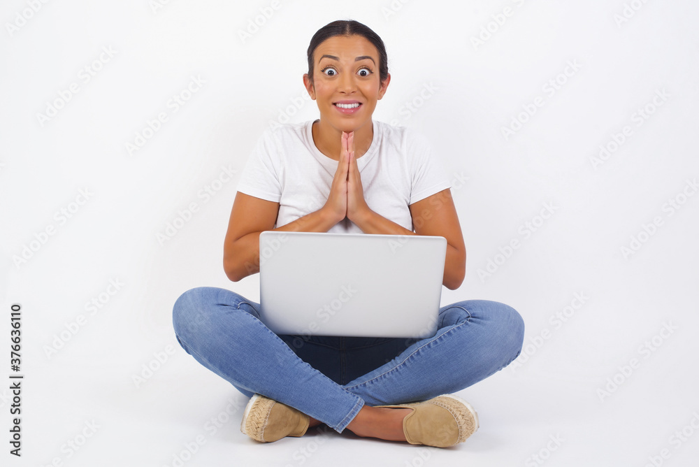 Horizontal portrait of pretty blonde woman keeps palms together, has pleased expression. Glad attractive female makes request, pleads for mercy. Hopeful young adult. Horizontal portrait of pretty blonde woman keeps palms together, has pleased expression. Glad attractive female makes request, pleads for mercy. Hopeful young adult.