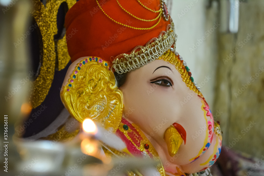 Dagdusheth ganpati small idol. Pooja of a small ganpati idol. View from  diya towards ganpati idol. Stock Photo | Adobe Stock