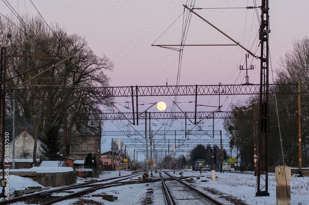 Obraz premium Widok zachodzące słońce na torami kolejowymi frakcja elektryczna