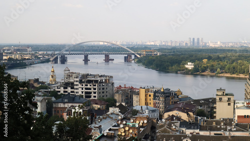 Top view of the old historical part of the city of Kiev. Vozdvizhenka area on Podol and the Dnieper river from the pedestrian bridge. Beautiful city landscape. 