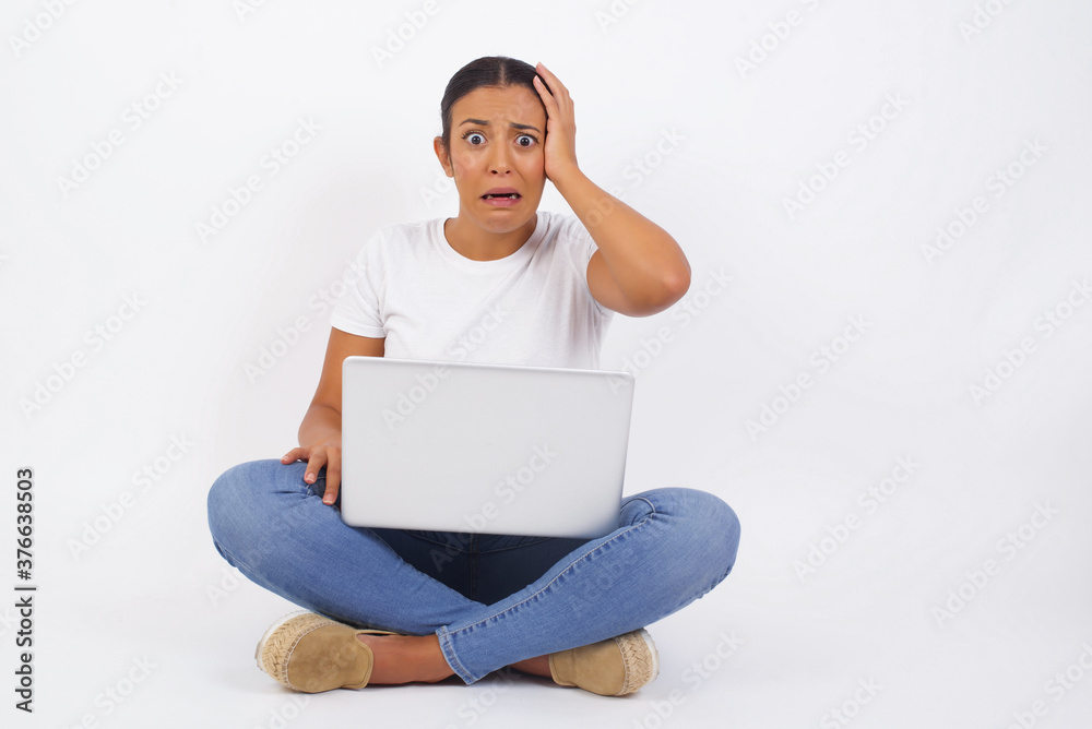 Worried and anxious woman can not remember anything. Portrait of confused cute girl wearing casual clothes, holding hand on hair and frowning, panicking, losing memory over gray wall Worried and anxious woman can not remember anything. Portrait of confused cute girl wearing casual clothes, holding hand on hair and frowning, panicking, losing memory over gray wall