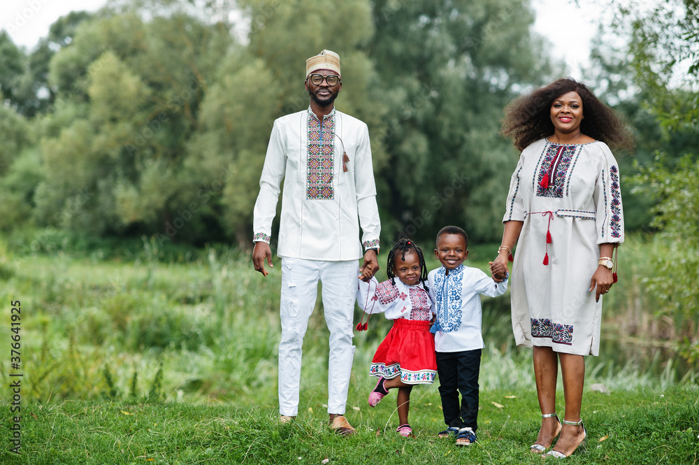 African family in traditional clothes at park. African family in traditional clothes at park.