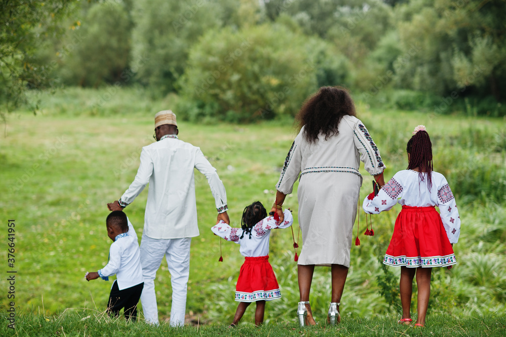 African family in traditional clothes at park. African family in traditional clothes at park.