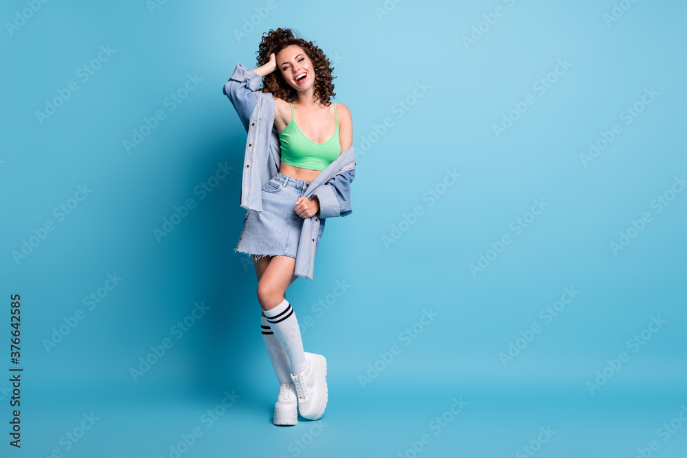 Full size photo of coquettish trend shine girl enjoy summer time holiday touch her hairdo enjoy excited wear street style outfit isolated over blue pastel color background Full size photo of coquettish trend shine girl enjoy summer time holiday touch her hairdo enjoy excited wear street style outfit isolated over blue pastel color background