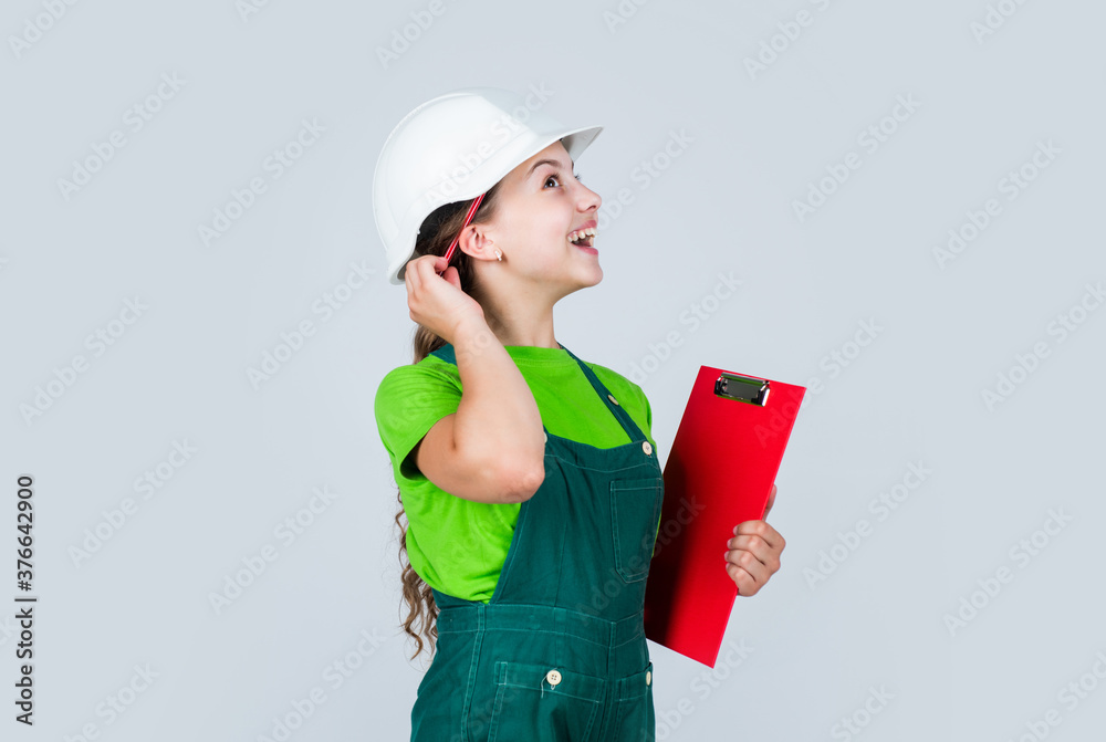 Kid worker with plan folder. little girl in helmet with folder on building site. builder in helmet thinking in front of plan. future interior designer. child in hardhat holding folder Kid worker with plan folder. little girl in helmet with folder on building site. builder in helmet thinking in front of plan. future interior designer. child in hardhat holding folder