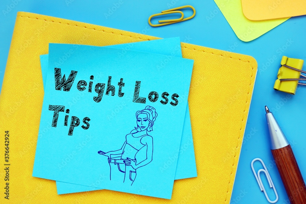 Weight Loss Tips inscription on the piece of paper. Weight Loss Tips inscription on the piece of paper.
