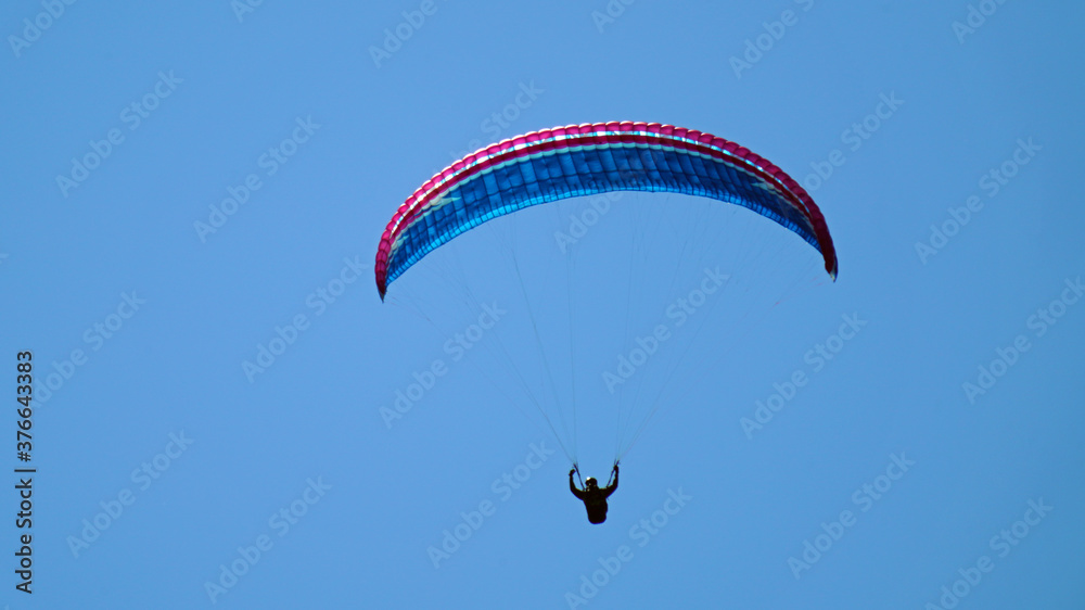 a paraglider on the clear blue sky a paraglider on the clear blue sky