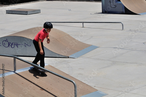 child learning to skate on a sunny day photo