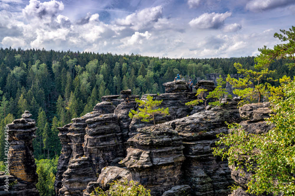 rock climbers enjoy the view from the top of a rock bastion in the Elbsandstone mountains in Saxon Switzerland