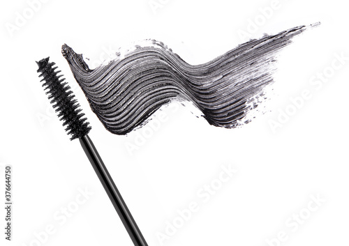 Black mascara brush stroke with applicator brush isolated on white	
