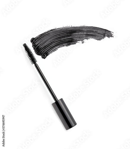 Black mascara brush stroke with applicator brush isolated on white	
 photo