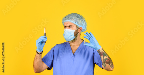 doctor wearing surgical mask while testing. nurse examines blood samples in lab. antibody for SARS can neutralize coronavirus. creation of antiviral vaccine. clinical trials. blood virus test