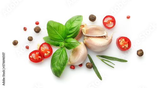 Ingredients for cooking, garlic, pepper, spices and herbs isolated on white background. Top view.