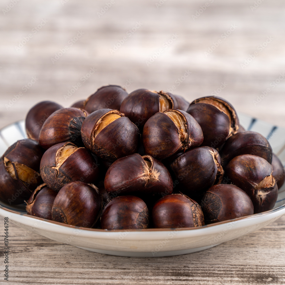 Delicious cut roasted chestnuts with oil and sugar, healthy eating snack in life, close up. Delicious cut roasted chestnuts with oil and sugar, healthy eating snack in life, close up.