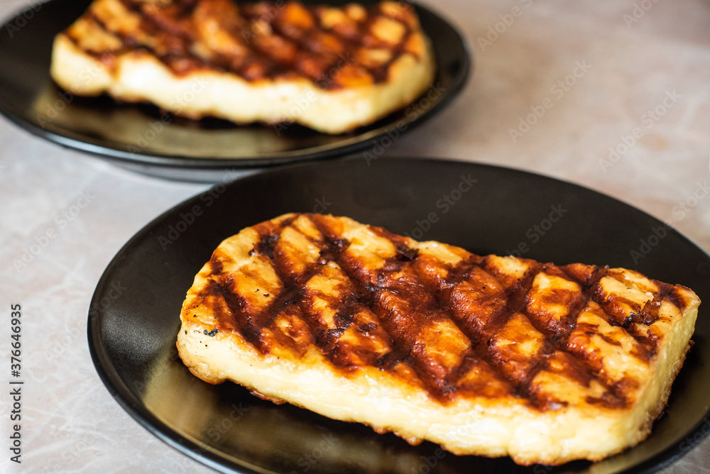 Grilled haloumi cheese on a plate Grilled haloumi cheese on a plate