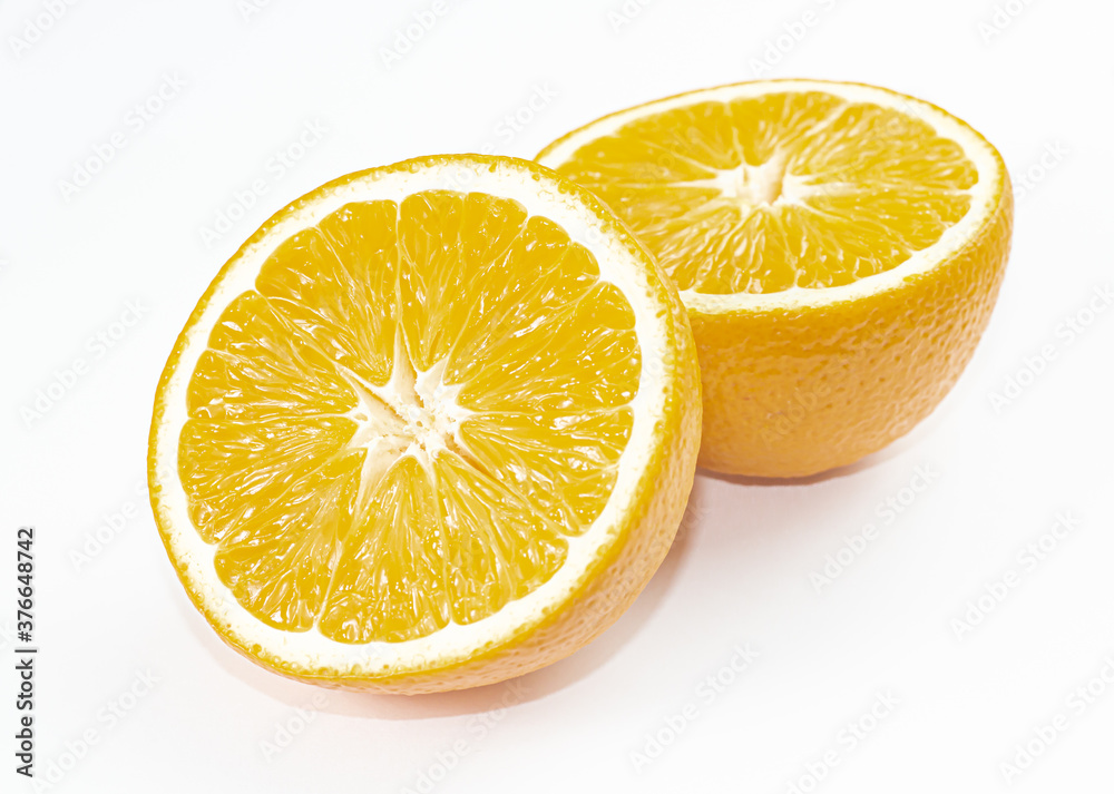 Two halves of orange flat lay. Closeup with orange and yellow pulp. White background with isolated space for text. Two halves of orange flat lay. Closeup with orange and yellow pulp. White background with isolated space for text.