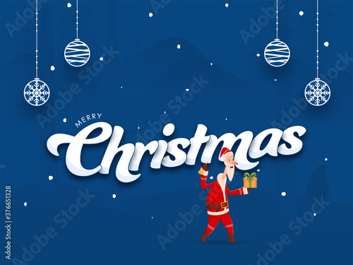 Merry Christmas Font with Cartoon Santa Claus Holding Gift Box  Jingle Bell and Hanging Baubles on Blue Background.
