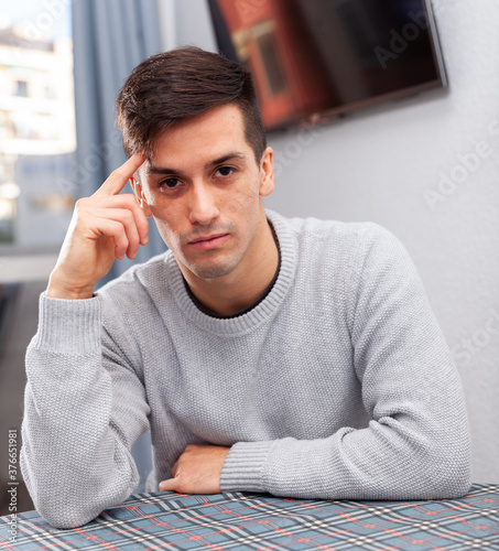 Portrait of confident young man at the home. High quality photo