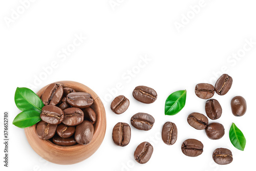 Heap of roasted coffee beans with leaves isolated on white background . Top view. Flat lay.