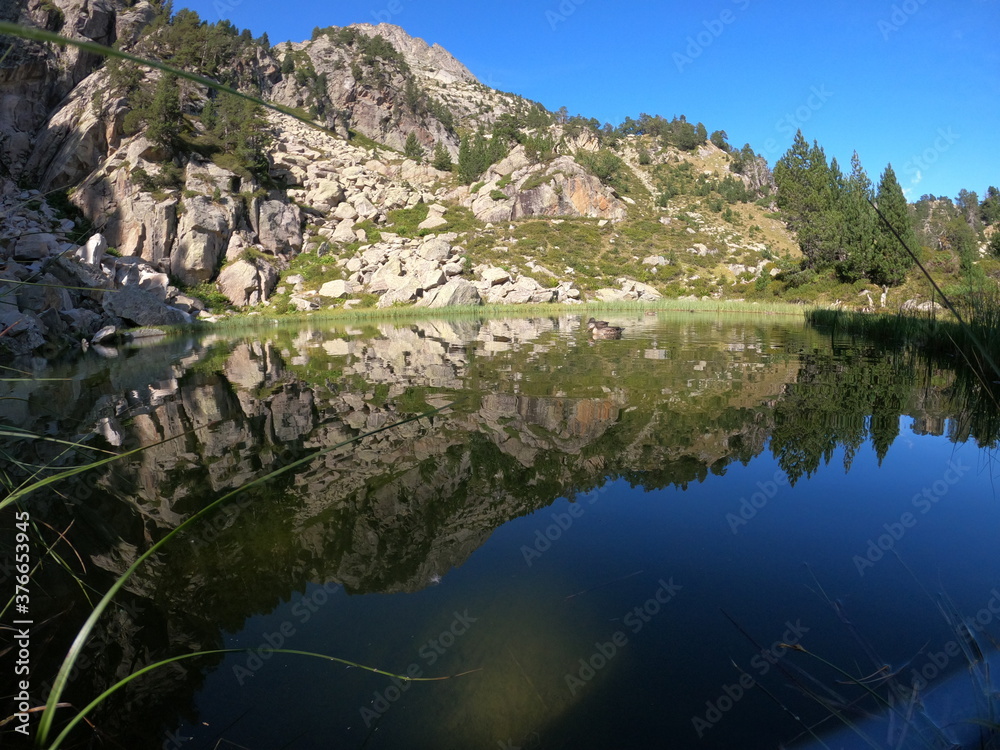 reflection of the mountains in a lake in Benasque