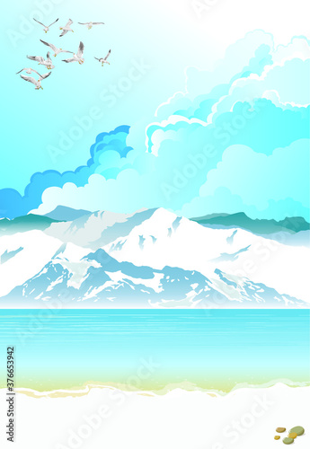 Picturesque arctic landscape with ocean and mountains set against a blue cloudy sky