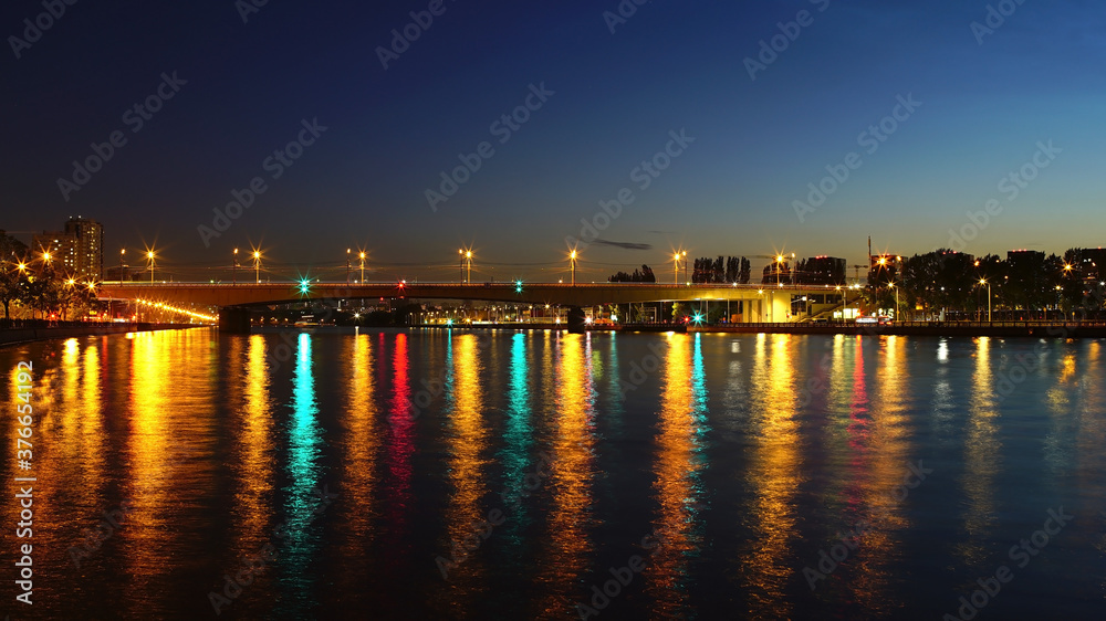 Night embankment of the Moscow river. metro-bridge. reflection of multicolored lanterns in the water