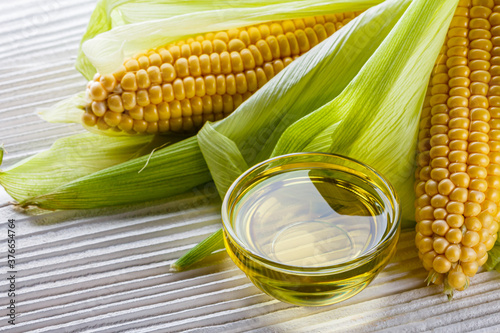 corn oil on white wooden rustic background
