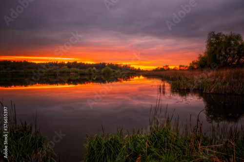 Long exposure fantastic sunset view on Bartatov Bartativ, Morozy village region Lviv. Lake and forest. Lviv district, Ukraine. May 2020