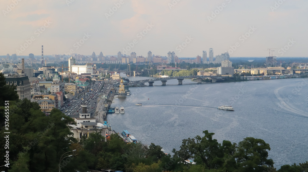 Top view of the old historical part of the city of Kiev. Vozdvizhenka area on Podol and the Dnieper river from the pedestrian bridge. Beautiful city landscape. 