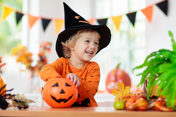 Child in Halloween costume. Kids trick or treat.