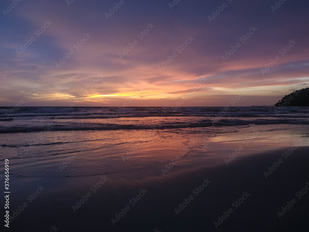 Yellow, orange, pink and purple sunset in the beach 