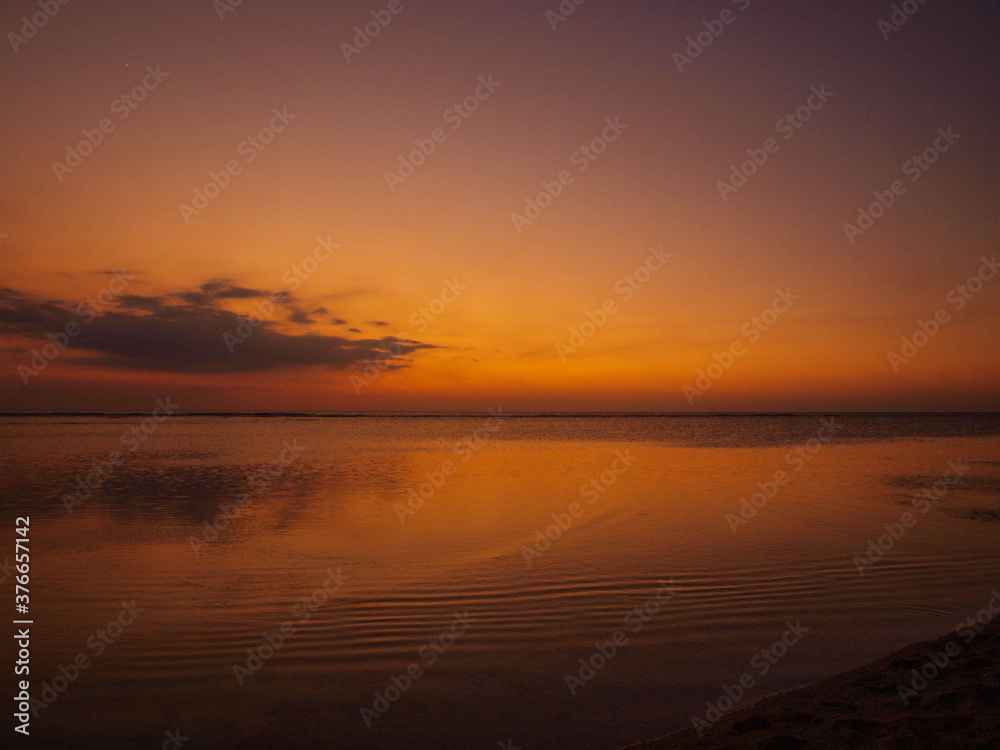 Yellow, orange, pink and purple sunset in the beach.