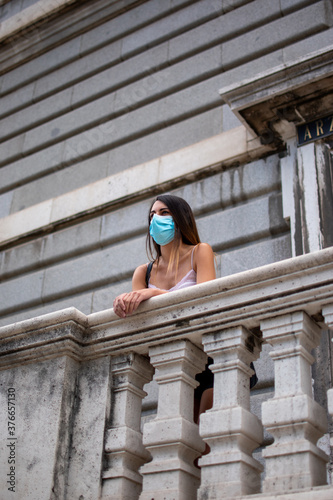 Vertical shot of a beautiful girl  wearing a medical mask - new normal