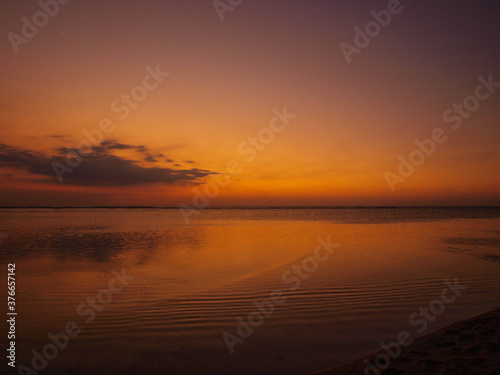 Yellow, orange, pink and purple sunset in the beach.
