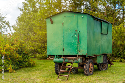 Old green rusty construction camper, trailer, van or wagon