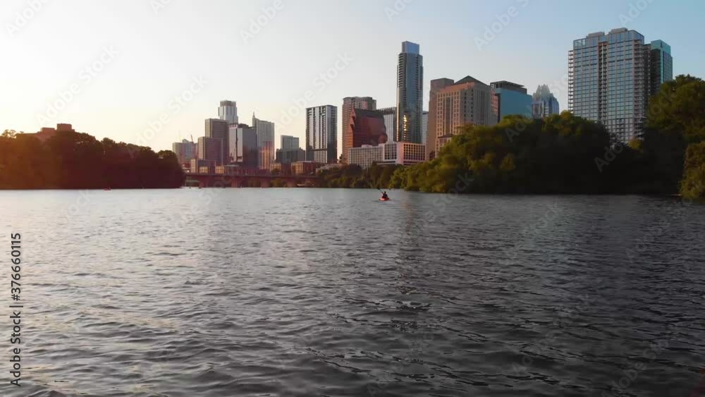 Kayaker paddling towards Downtown Austin Texas. Straight shot that follows the Kayaker. August 2020 Kayaker paddling towards Downtown Austin Texas. Straight shot that follows the Kayaker. August 2020