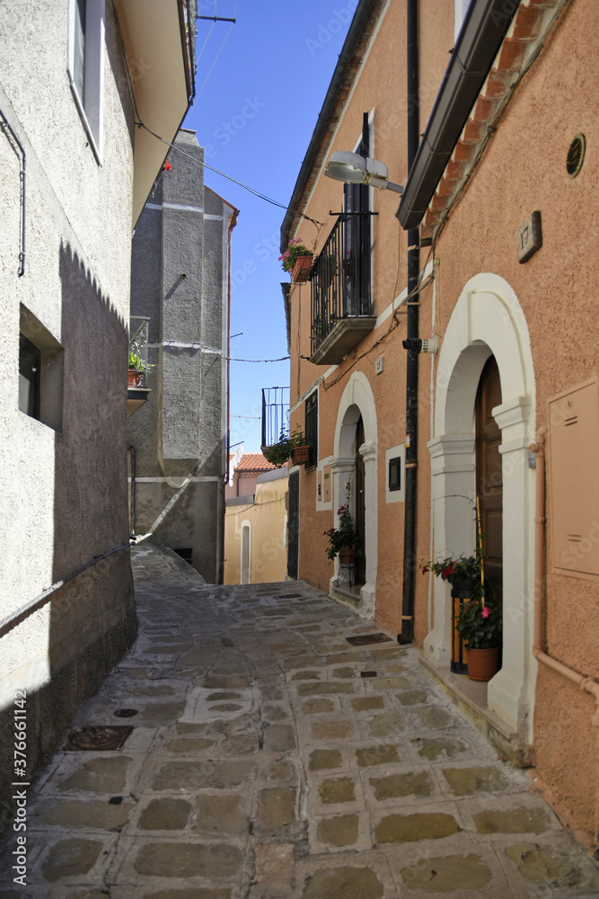 A small road crosses the old buildings of Viggiano, a rural village in the Basilicata region, Italy.