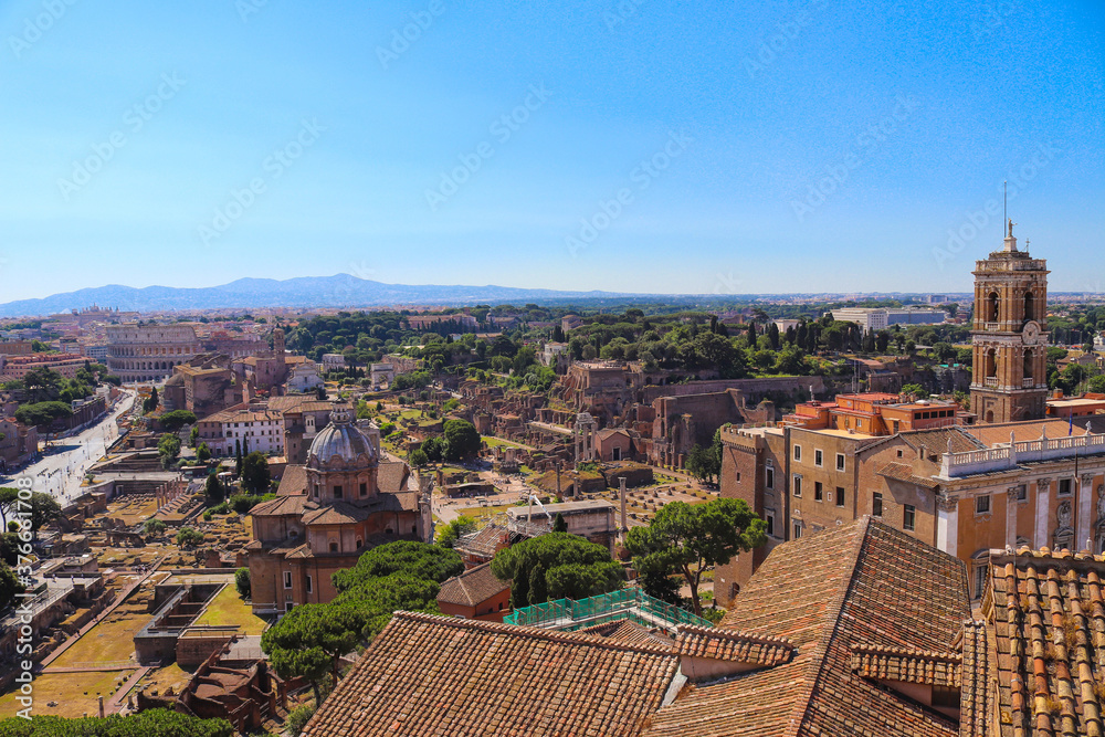 Cityscape view of the Roman Forum and historic city center in Italy during summer sunny day. Ancient Roman architecture