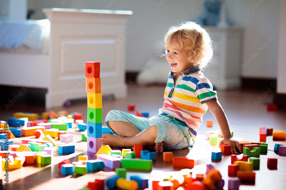 Child playing with colorful toy blocks. Kids play. Child playing with colorful toy blocks. Kids play.