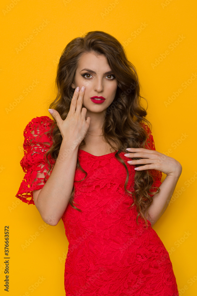 Beautiful Woman In Elegant Red Lace Dress Holds Two Fingers On Her Cheek Beautiful Woman In Elegant Red Lace Dress Holds Two Fingers On Her Cheek