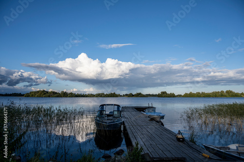 view of a large beautiful lake against the backdrop of clouds and blue sky