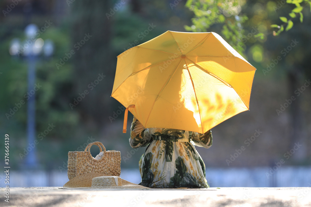women with umbrella in summer park