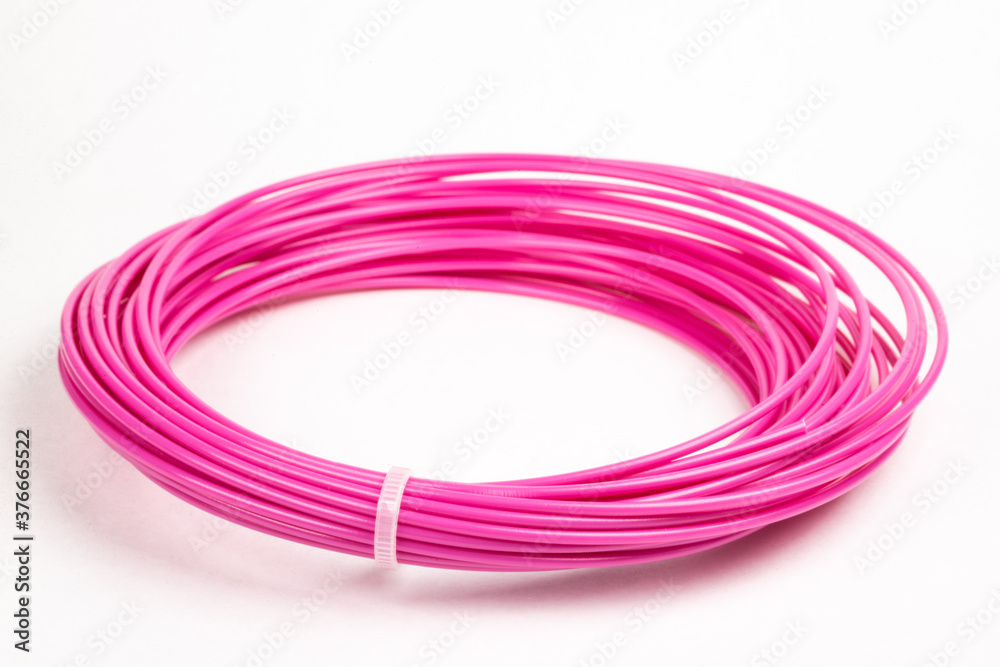 Top view of crimson rolled filament plastic for 3D Printing Pen isolated on white.
