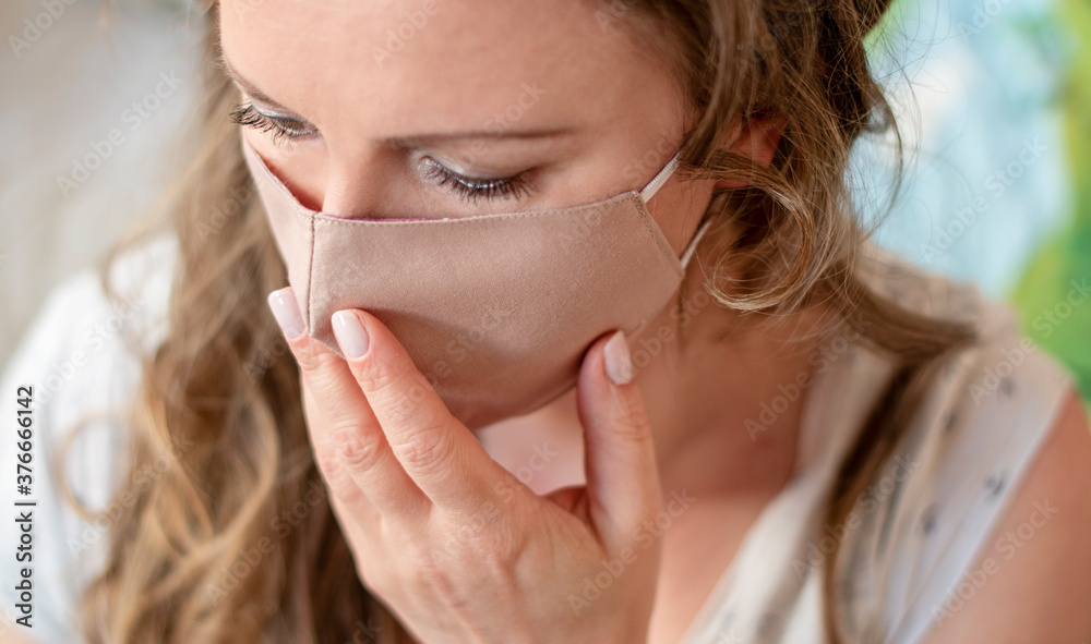 Portrait of woman wearing handmade cotton fabric face mask. Protection against saliva, cough, dust, pollution, virus, bacteria, COVID-19 disease, infection. Coronavirus patient. Portrait of woman wearing handmade cotton fabric face mask. Protection against saliva, cough, dust, pollution, virus, bacteria, COVID-19 disease, infection. Coronavirus patient.