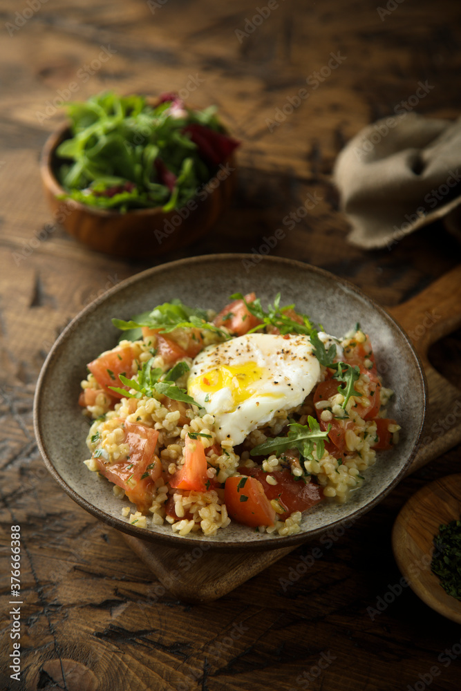 Healthy warm bulgur salad with poached egg Healthy warm bulgur salad with poached egg