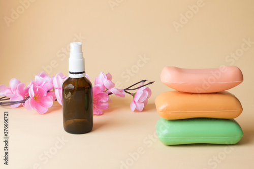 Stack of soap with pink flower and floral spray 