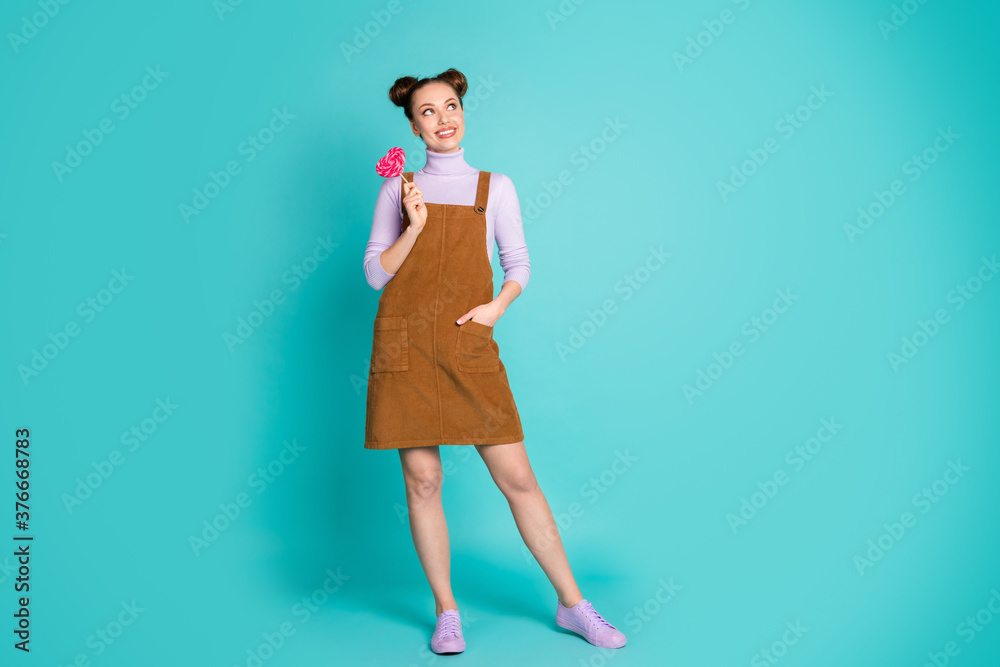 Full size photo of cute romantic childish thoughtful two buns hairstyle girlfriend lady hold caramel look empty space wear purple sneakers sweater brown dress isolated teal color background Full size photo of cute romantic childish thoughtful two buns hairstyle girlfriend lady hold caramel look empty space wear purple sneakers sweater brown dress isolated teal color background