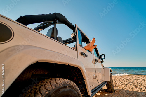 Woman with car on beach