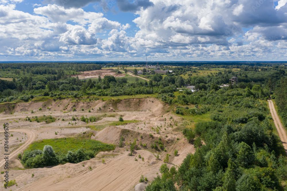 Aerial view of old gravel quarry and cloudy sky